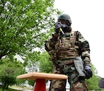 A member of the 118th Emergency Management Office checks M9 paper for contamination April 8, 2022, at Berry Field Air National Guard base, Nashville, Tennessee. Members from across the 118th Wing took part in the largest on-base readiness exercise in wing history April 5-9, to prepare for a near-peer conflict.