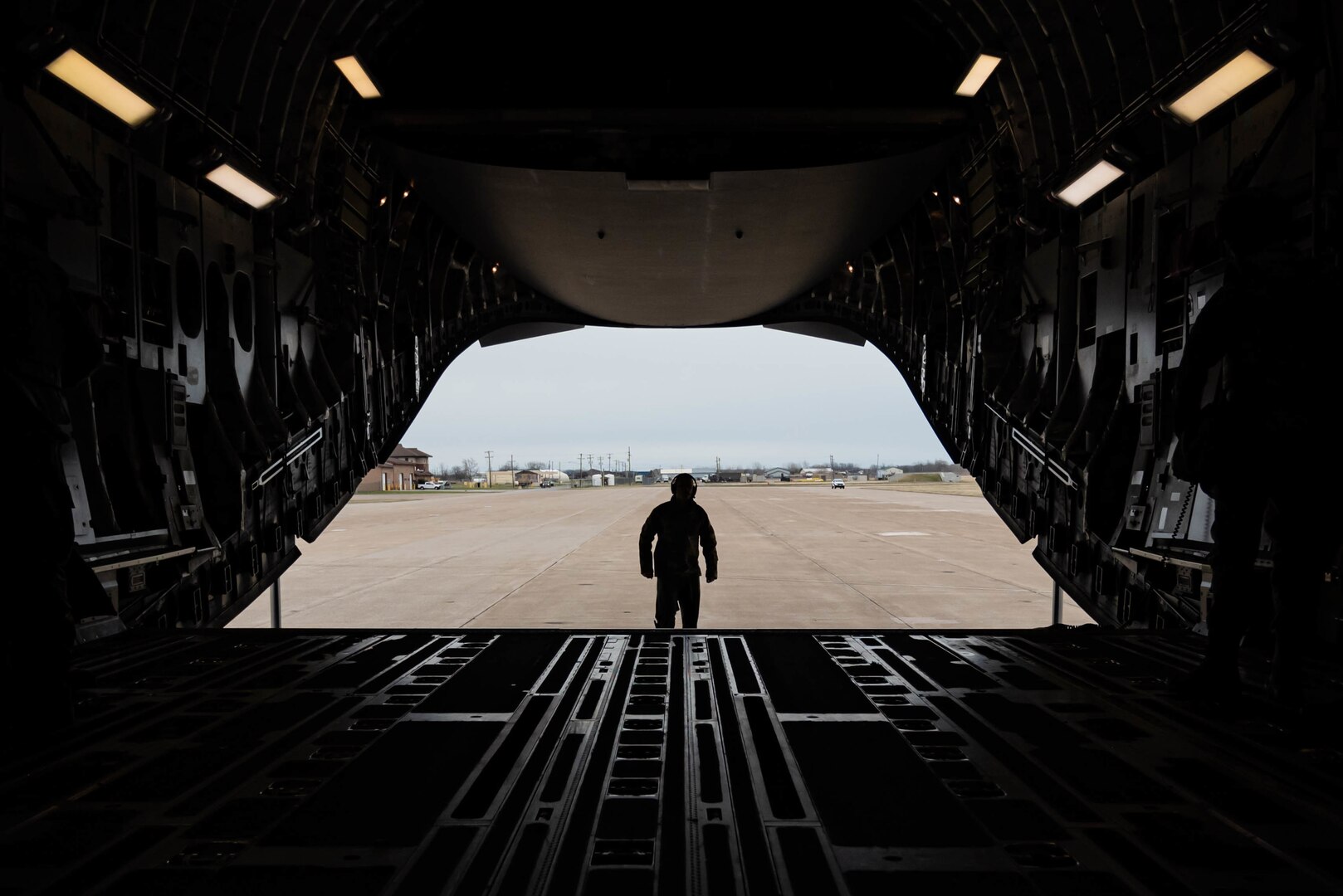 An Airman looks over a C-17 Globemaster III on its landing at Niagara Falls Air Reserve Station, Niagara Falls, New York, during a readiness exercise April 7, 2022. The exercise demonstrated the 107th Attack Wing’s capability to generate personnel and cargo under contested, degraded and operationally limited conditions.