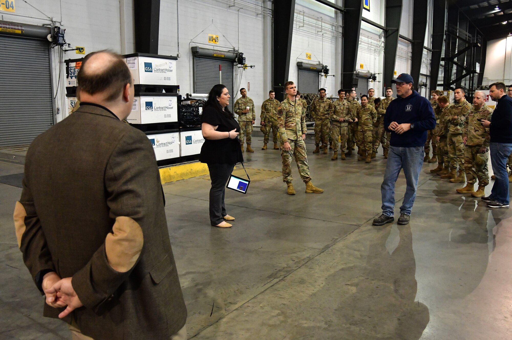 Angela Garza, Cougaar Software senior operations research engineer, discusses capabilities of the Configured Air Load Building Tool at Dover Air Force Base, Delaware, April 8, 2022. The software company developed the CALBT, as part of the "Aerial Port of the Future" initiative to maximize pallet space utilization within Air Mobility Command. (U.S. Air Force photo by Master Sgt. Chuck Broadway)