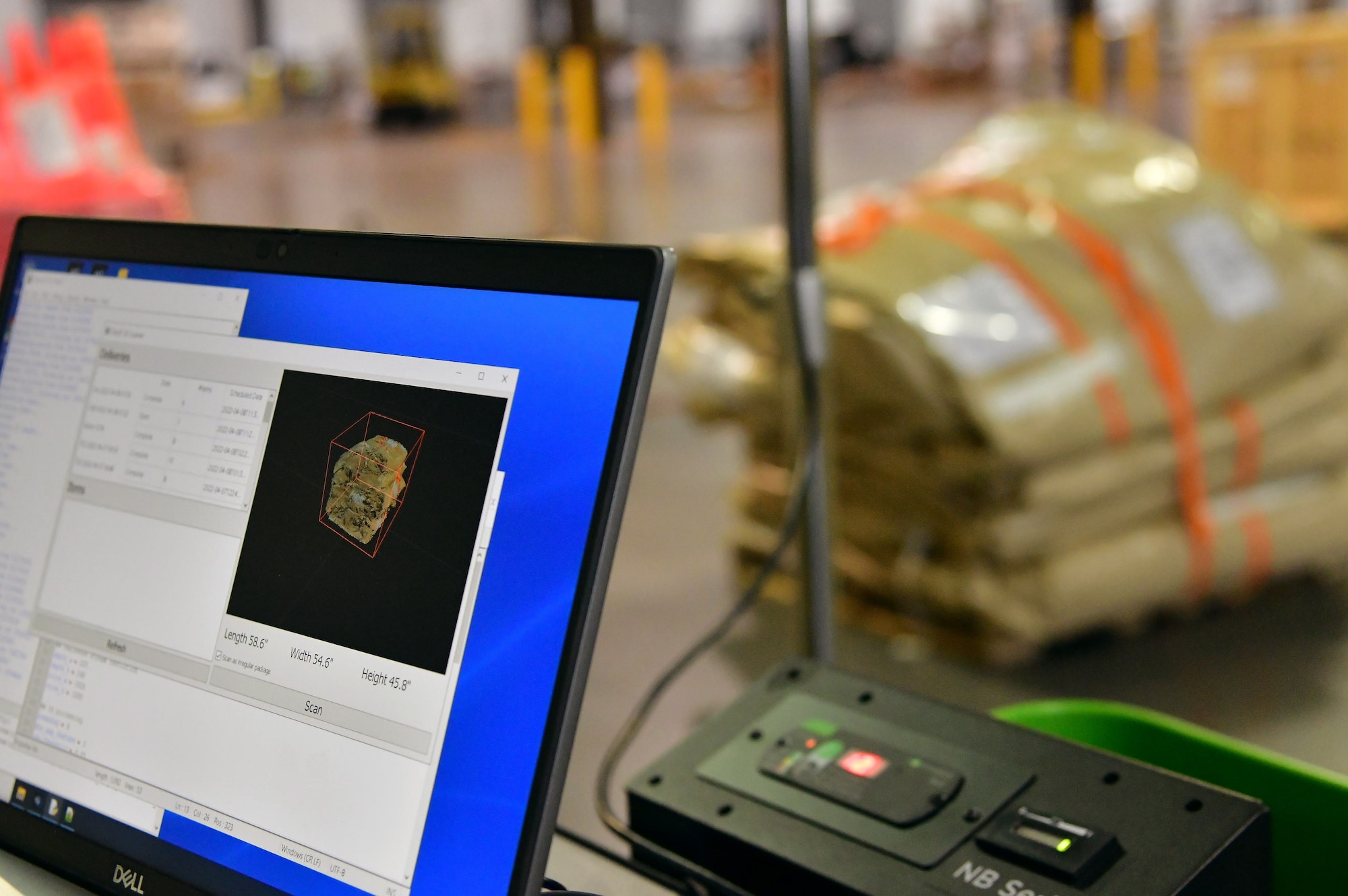 The Configured Air Load Building Tool scans cargo at the 436th Aerial Port Squadron on Dover Air Force Base, Delaware, April 8, 2022. The system was developed as part of the "Aerial Port of the Future" initiative to maximize pallet space utilization. (U.S. Air Force photo by Master Sgt. Chuck Broadway)