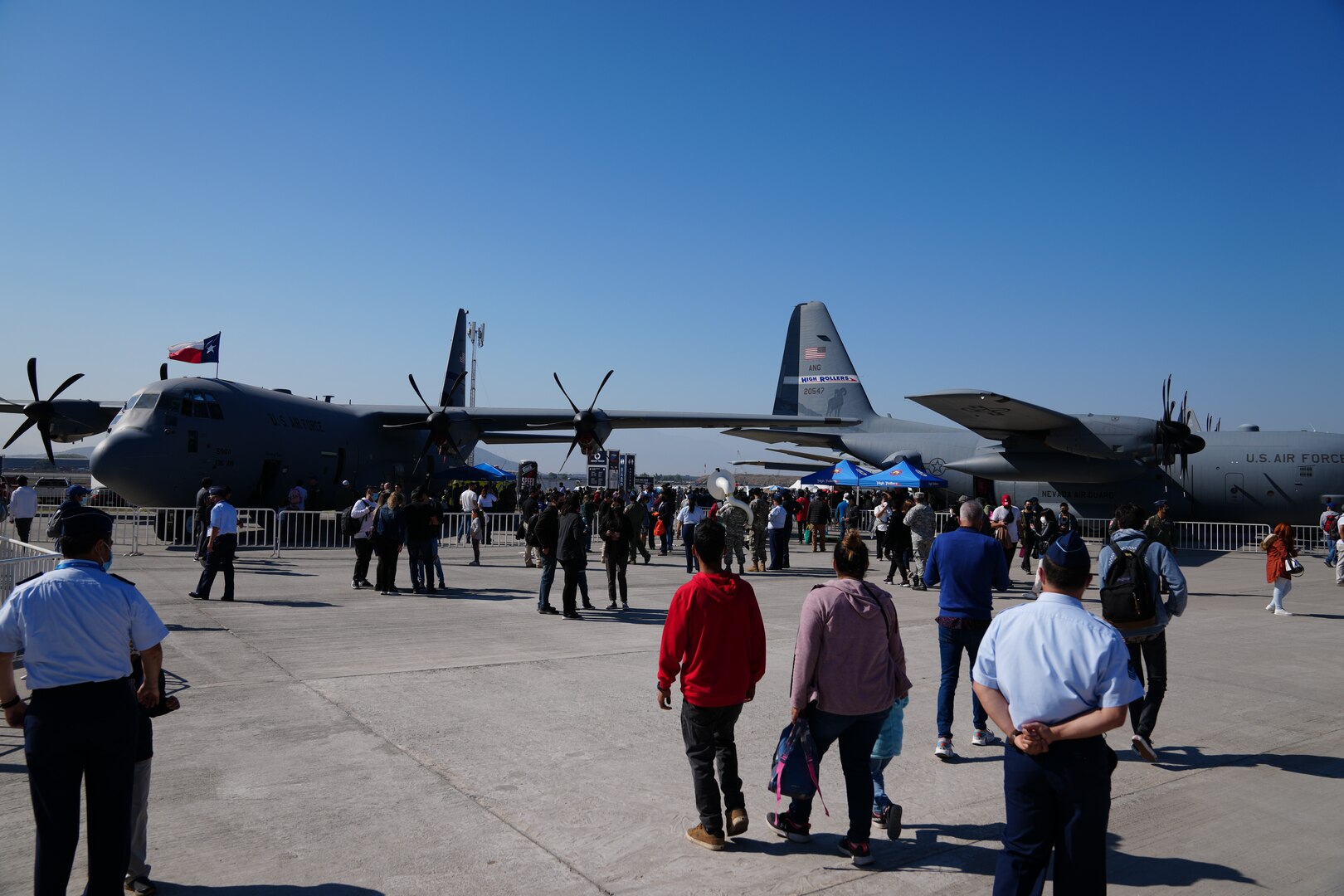 Airshow goers make their way toward the C-130 cargo aircraft from the Texas and Nevada Air National Guard at Feria Internacional del Aire y del Espacio (FIDAE), Latin America’s largest aerospace, defense and security exhibition, in Santiago, Chile, April 8, 2022.