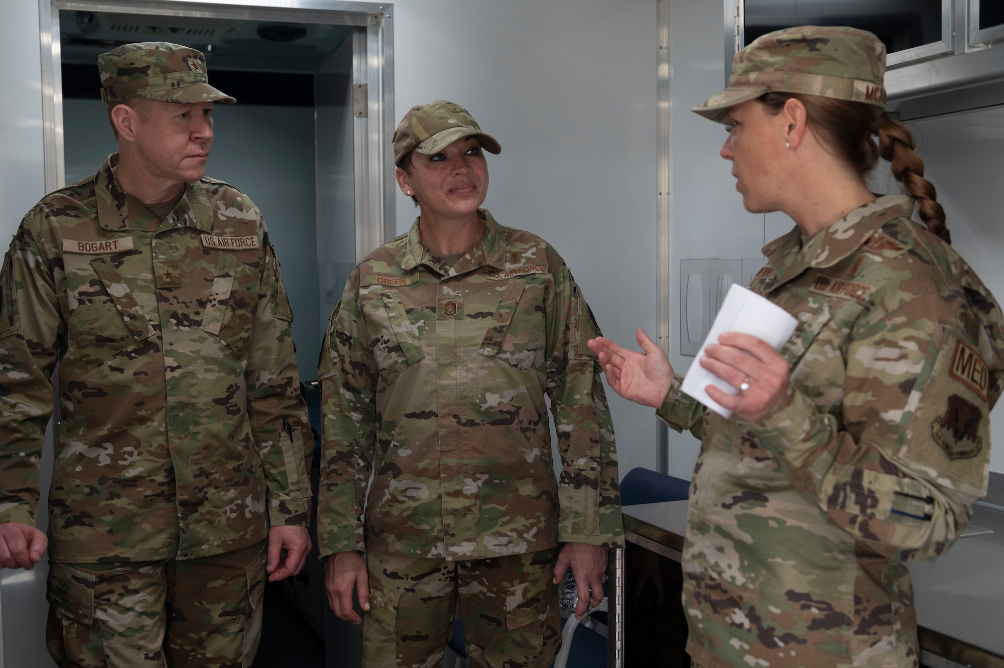 Brig. Gen. (Dr.) Robert Bogart, Air Combat Command command surgeon (left), and Chief Master Sgt. Kimberly Green, Air Combat Command chief of medical enlisted force, are briefed about the 4th Medical Group’s medical trailer by Lt. Col. Hattie McAviney, 4th Operational Medical Readiness Squadron commander, during a tour at Seymour Johnson Air Force Base, North Carolina, April 6, 2022. The 4th MDG has the second medical trailer in the Air Force which is used for mass-processing of Airmen. (U.S. Air Force photo by Senior Airman Kevin Holloway)