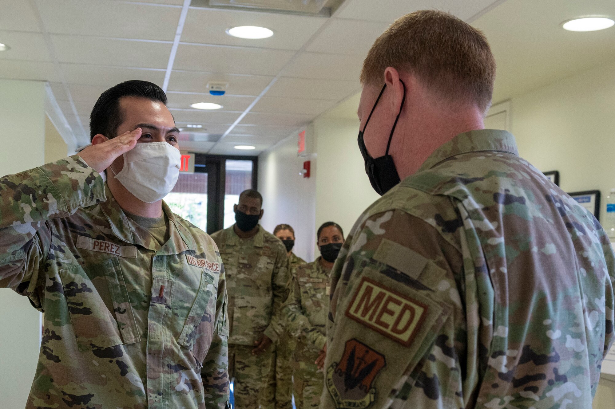 2nd Lt. Adrian Perez, 4th Medical Group medical readiness flight commander (left), salutes Brig. Gen. (Dr.) Robert Bogart, Air Combat Command command surgeon during a tour at Seymour Johnson Air Force Base, North Carolina, April 6, 2022. Bogart toured the 4th MDG and the Kiecker Dental Clinic talking to Airmen about their day-to-day occupations. (U.S. Air Force photo by Senior Airman Kevin Holloway)