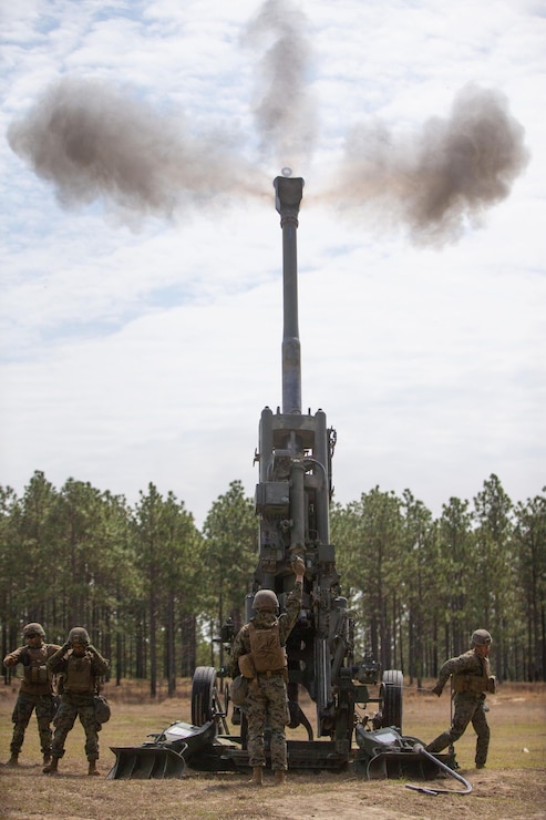U.S. Marines with Echo Battery, 2d Battalion, 10th Marine Regiment, 2d Marine Division, fire an M777 howitzer during Exercise Rolling Thunder 22-2 on Fort Bragg, North Carolina, March 29, 2022. This exercise is a 10th Marines-led live fire artillery event that tested the unit’s abilities to operate in a simulated littoral environment against a peer threat in a dynamic and multi-domain scenario. (U.S. Marine Corps photo by Lance Cpl. Ryan Ramsammy)