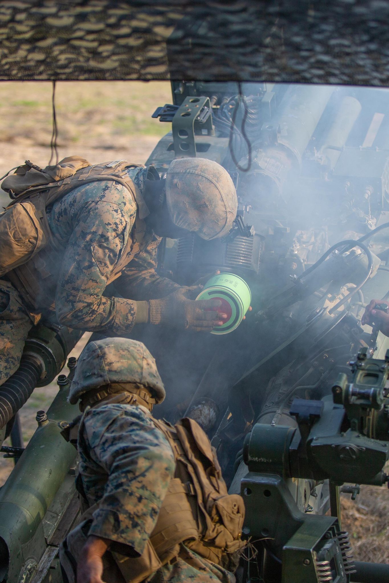 U.S. Marines with Echo Battery, 2d Battalion, 10th Marine Regiment, 2d Marine Division, load a charge propellant into an M777 howitzer during Exercise Rolling Thunder 22-2 on Fort Bragg, North Carolina, March 29, 2022.
