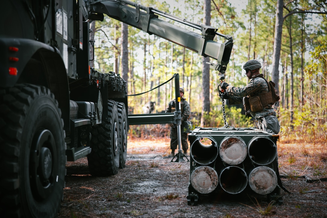 U.S. Marine Corps Lance Cpl. Matthew Snow, field artillery cannoneer with Sierra Battery, 2d Battalion, 10th Marine Regiment, loads a reduced range practice rocket during Exercise Rolling Thunder 22-2 at Camp Lejeune, North Carolina, March 29, 2022. The Marines utilized the newly-fielded equipment gaining proficiency in constructing combat expedient roads and providing obstacle clearance for moving troops and logistics throughout a contested environment. (U.S. Marine Corps photo by Sgt. Corey Mathews)