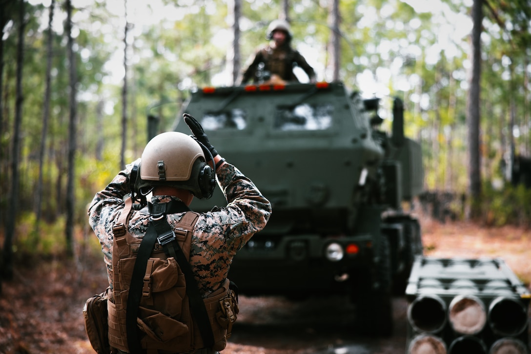 U.S. Marine Corps Sgt. Mark Azucar, field artillery cannoneer with Sierra Battery, 2d Battalion, 10th Marine Regiment, guides a High Mobility Artillery Rocket System (HIMARS) during Exercise Rolling Thunder 22-2 at Camp Lejeune, North Carolina, March 29, 2022.