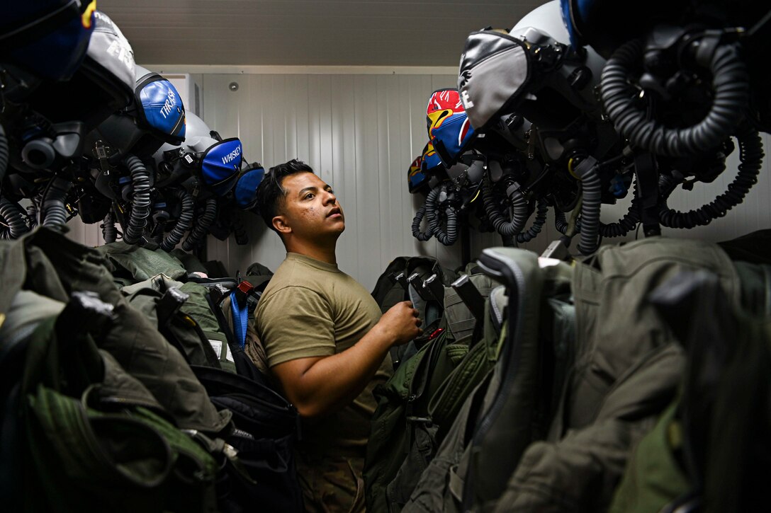 An airman inspects flight equipment.