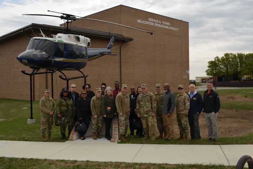 Col. Tyler Schaff, 316th Wing and Joint Base Andrews installation commander, 316th Wing senior leaders, and Joint Base Andrews honorary commanders pose in front of a 1st Helicopter Squadron UH-1N Huey Helicopter during the Honorary Commanders Program quarterly visit at Joint Base Andrews, Md., April 4, 2022.