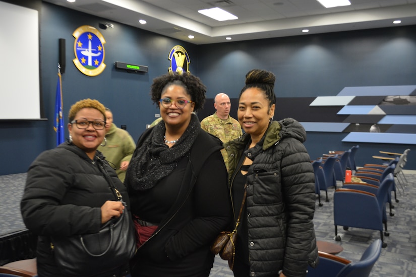 Dr. Tameka Woodruff, science and technology program coordinator, Oxon Hill High School, Dr. Felicia Martin-Latief, STEM instructional supervisor for Prince George's County Public Schools, and Mrs. Samantha Cotton, science & technology program coordinator, Charles H. Flowers High School, pose following a mission brief in the auditorium of the Helicopter Operations Facility during the Honorary Commanders Program quarterly visit at Joint Base Andrews, Md., April 4, 2022.
