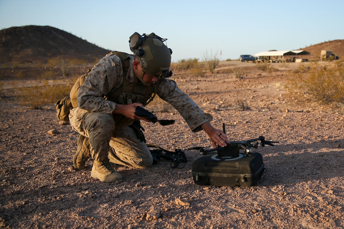U.S. Marine Corps Lance Cpl. Amadteus Fitzgerald, a native of New Castle, Delaware, and a rifleman with 1st Battalion, 2d Marine Regiment, 2d Marine Division (MARDIV), prepares a Skydio small unmanned aircraft system for flight during Weapons and Tactics Instructor (WTI) course 2-22 at Laguna Army Airfield, Yuma Proving Ground, Arizona, April 4, 2022. WTI is a seven-week training event, hosted by Marine Aviation Weapons and Tactics Squadron One, which emphasizes the development of small task-organized unit experimentation across all warfighting functions, as well as enhance the battalion's ability to conduct command and control, fire-support planning, intelligence functions, and logistical support to distributed company level operations. This exercise continues support of 2d MARDIV's experimental battalion's assessment and mission essential task list-based pre-deployment training progression. (U.S. Marine Corps photo by Pfc. Sarah Pysher)