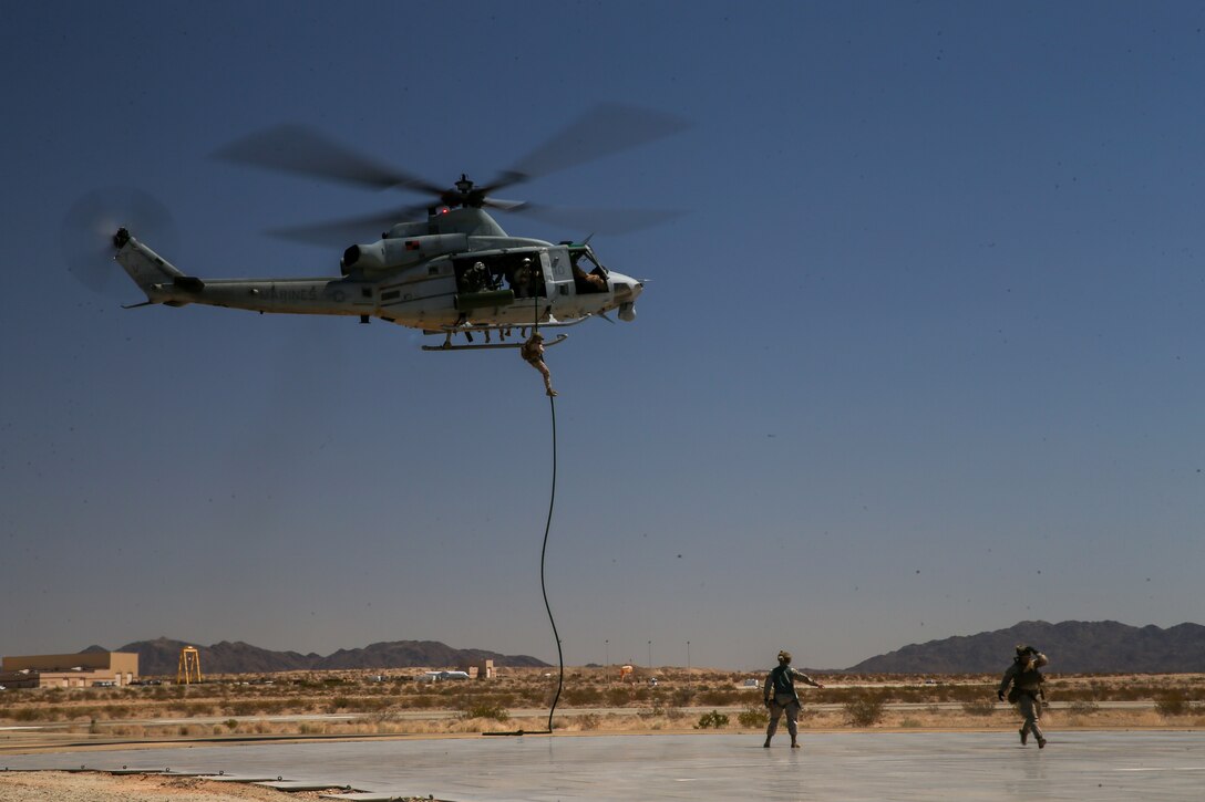 U.S. Marines with 1st Battalion, 2d Marine Regiment, 2d Marine Division (MARDIV), conduct fast-rope training during Weapons and Tactics Instructor (WTI) course 2-22 at Laguna Army Airfield, Yuma Proving Ground, Arizona, April 2, 2022. WTI is a seven-week training event, hosted by Marine Aviation Weapons and Tactics Squadron One, which emphasizes the development of small task-organized unit experimentation across all warfighting functions, as well as enhance the battalion's ability to conduct command and control, fire-support planning, intelligence functions, and logistical support to distributed company level operations. This exercise continues support of 2d MARDIV's experimental battalion's assessment and mission essential task list-based pre-deployment training progression. (U.S. Marine Corps photo by Pfc. Sarah Pysher)