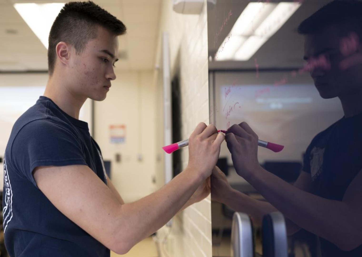 A U.S. Coast Guard Academy cadet, a member of the Academy's cyber team, writes out information on a blackboard while participating in the National Security Agency's (NSA) annual cyber exercise (NCX), here, Mar. 31, 2022. The Academy's cyber team won third place out of 12 total teams. (U.S. Coast Guard photo by Petty Officer 3rd Class Matthew Abban)