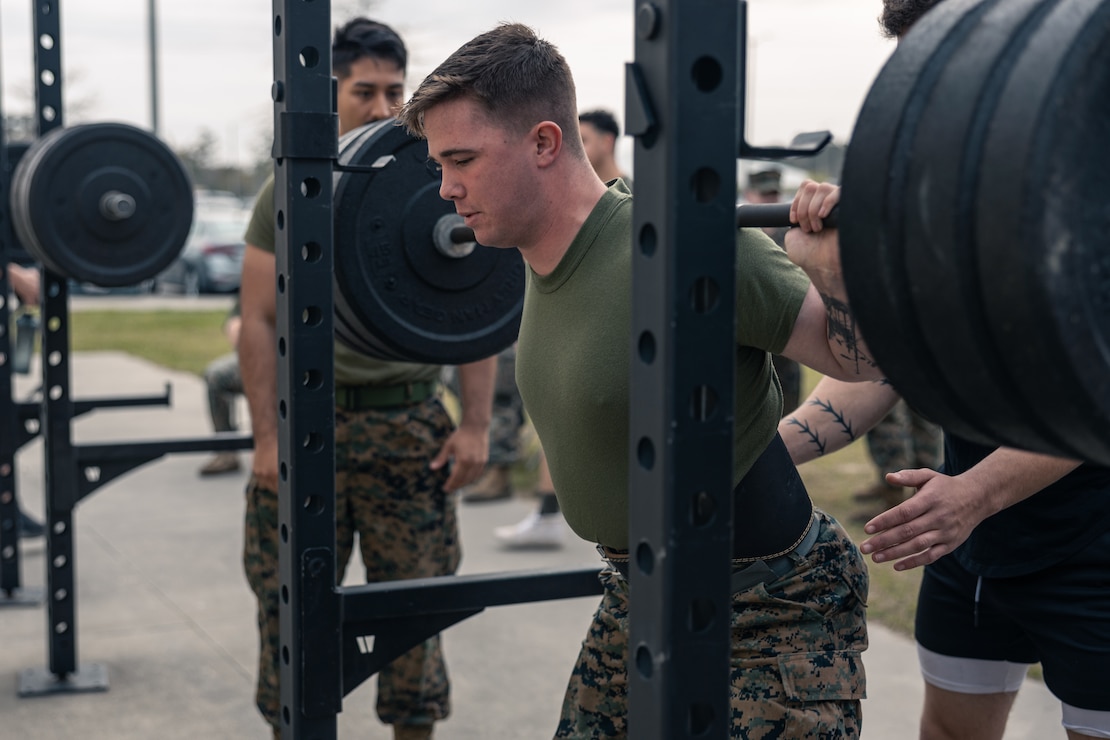 U.S. Marines with 2d Battalion, 2d Marine Regiment (2/2), 2d Marine Division, participate in a weightlifting competition during the Warlord Games II on Camp Lejeune, North Carolina, March 31, 2022. The Warlord Games is a quarterly event where Marines from 2/2 compete in various competitions to strengthen the unit's esprit de corps. (U.S. Marine Corps photo by Lance Cpl. Deja Thomas)