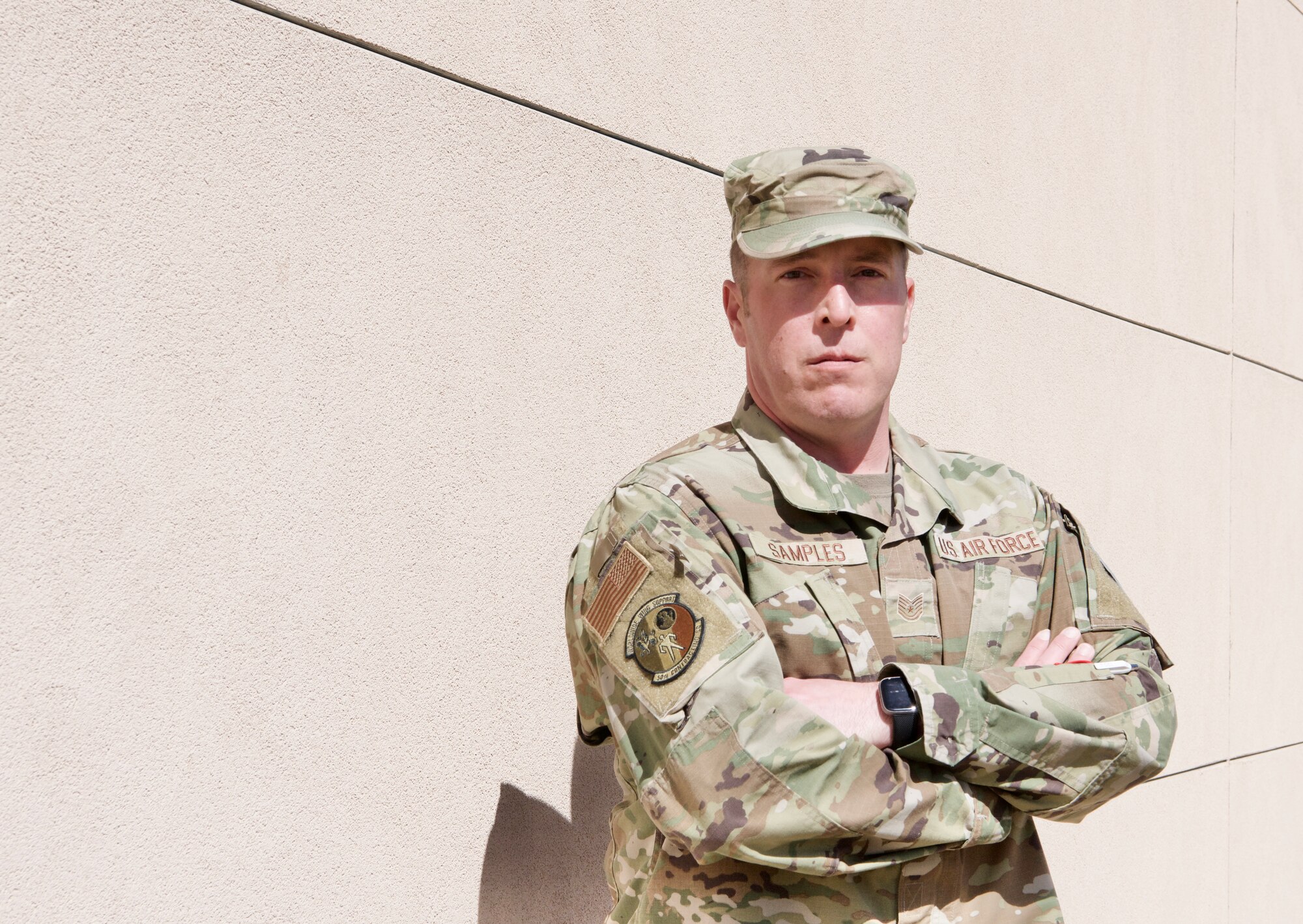 U.S. Air Force Tech. Sgt. Joshua Samples, the noncommissioned officer in charge with the 50th Contracting Squadron’s Rapid Construction Team, shields his eyes from the bright Centennial State sun while posing for a photo on April 5, 2022 at Schriever Space Force Base, Colorado.