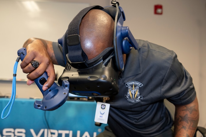 U.S. Air Force Chief Master Sgt. Mark Moore, 492d Special Operations Training Group senior enlisted advisor, simulates using a flashlight as part of an Air Force Integrated Technology Platform Virtual Reality demonstration, April 5-6, at Hurlburt Field, Florida.