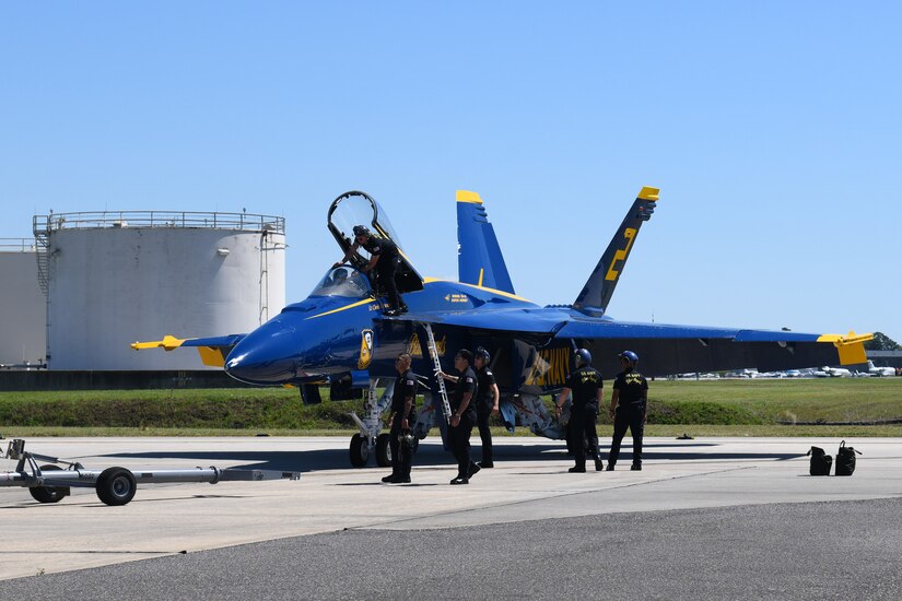 Crew members from the Blue Angels perform maintenance on a F/A-18 Super Hornet at the Titans of Flight Air Expo, Joint Base Charleston, South Carolina, April 7, 2022.
