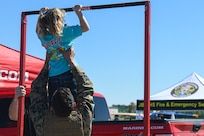 An Air Expo attendee participates in a U.S. Marine Corps recruitment display at the Titans of Flight Air Expo, Joint Base Charleston, South Carolina, April 10, 2022.