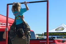An Air Expo attendee participates in a U.S. Marine Corps recruitment display at the Titans of Flight Air Expo, Joint Base Charleston, South Carolina, April 10, 2022.