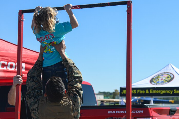 An Air Expo attendee participates in a U.S. Marine Corps recruitment display at the Titans of Flight Air Expo, Joint Base Charleston, South Carolina, April 10, 2022.