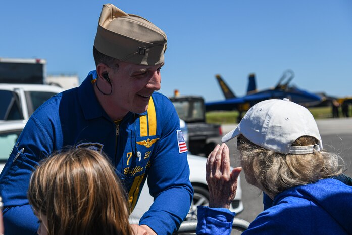 A U.S. Navy Lt. Griffin Strangel assigned to the Blue Angels interacts with Air Expo attendees at the Titans of Flight Air Expo, Joint Base Charleston, South Carolina, April 10, 2022.