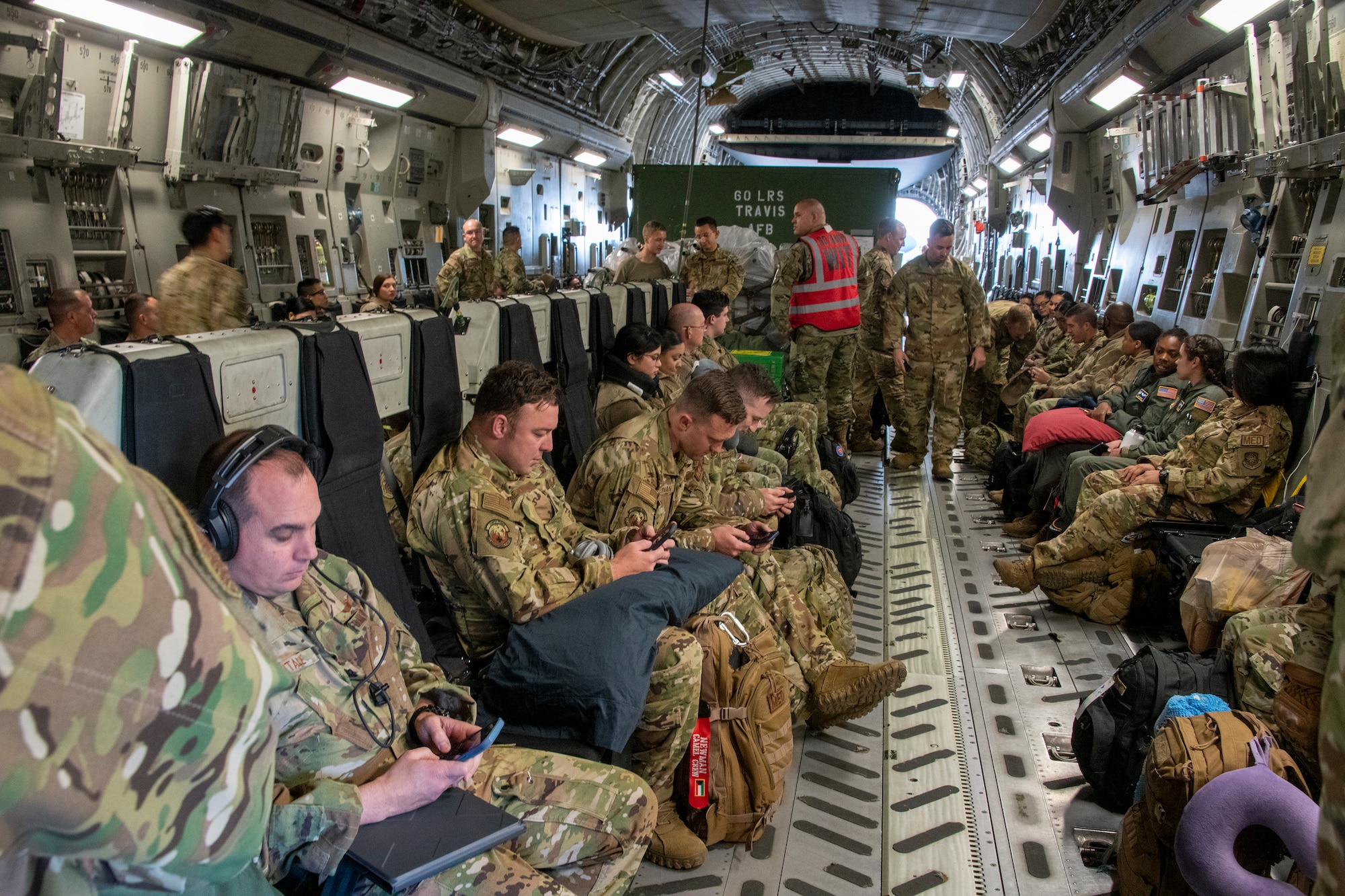 Airmen sit inside a C-17