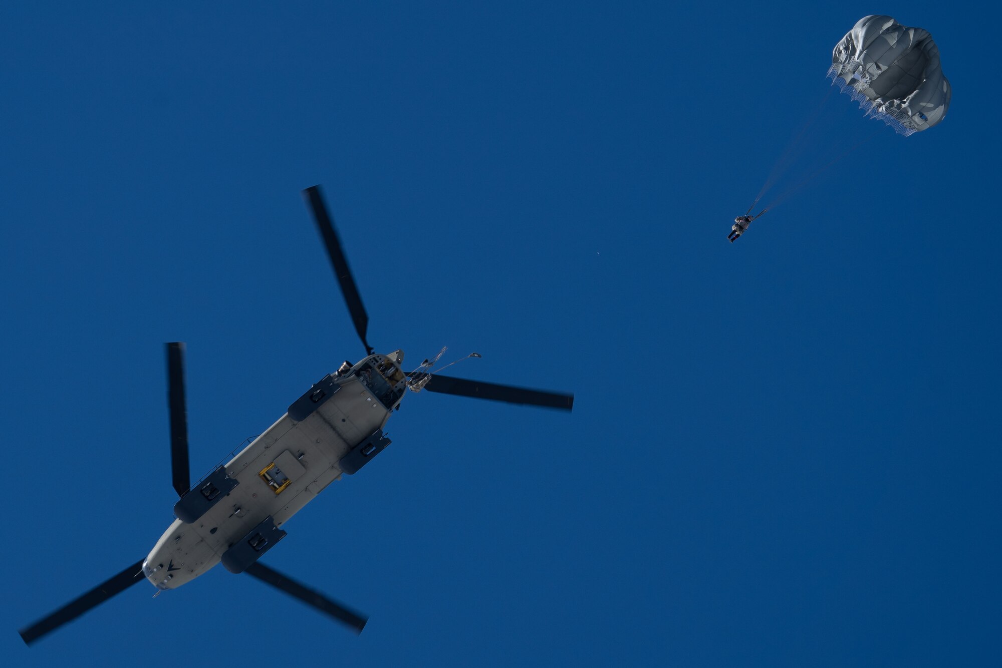 Photo of Airmen jumping from a Chinook