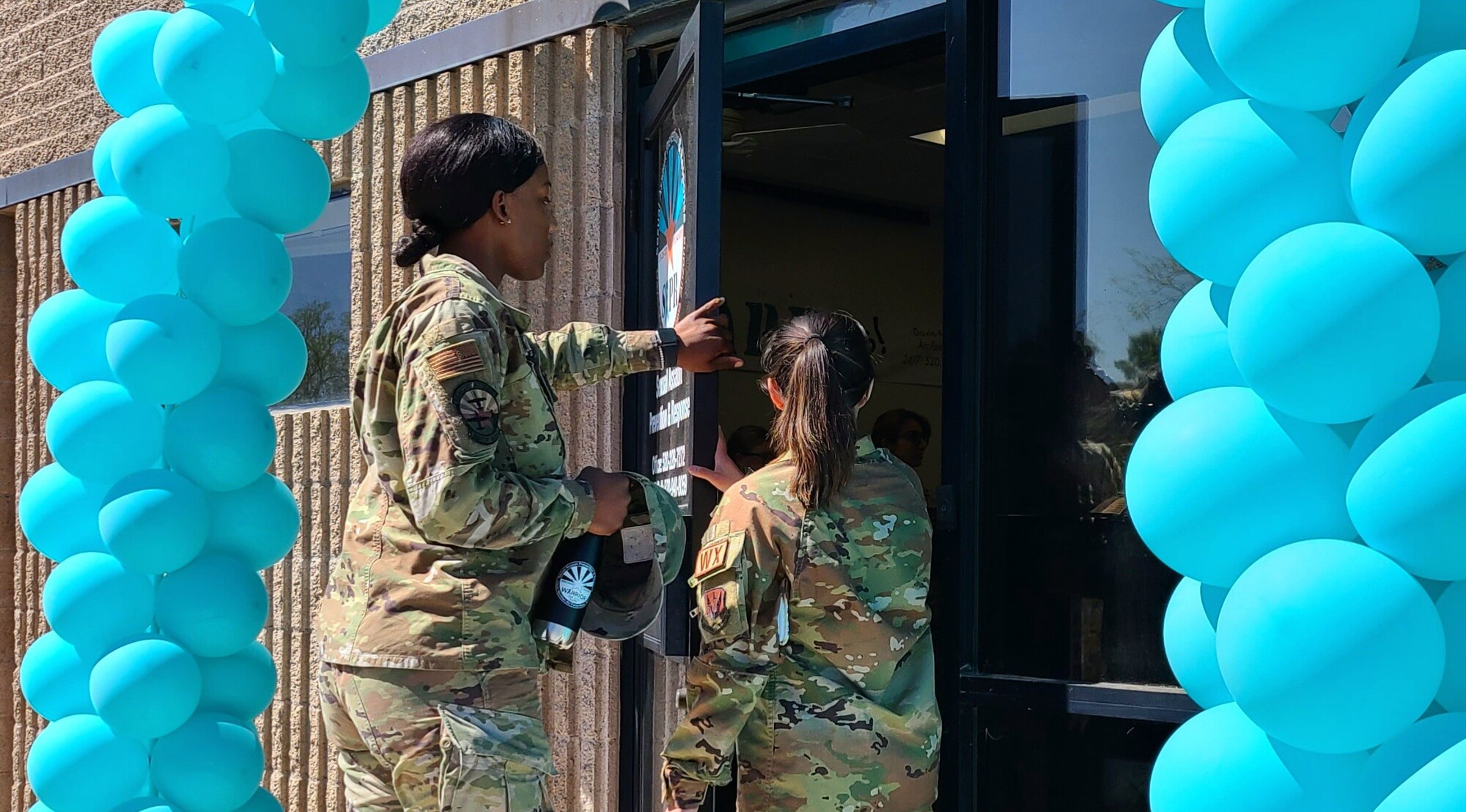 A photo of Airmen walking through the door.
