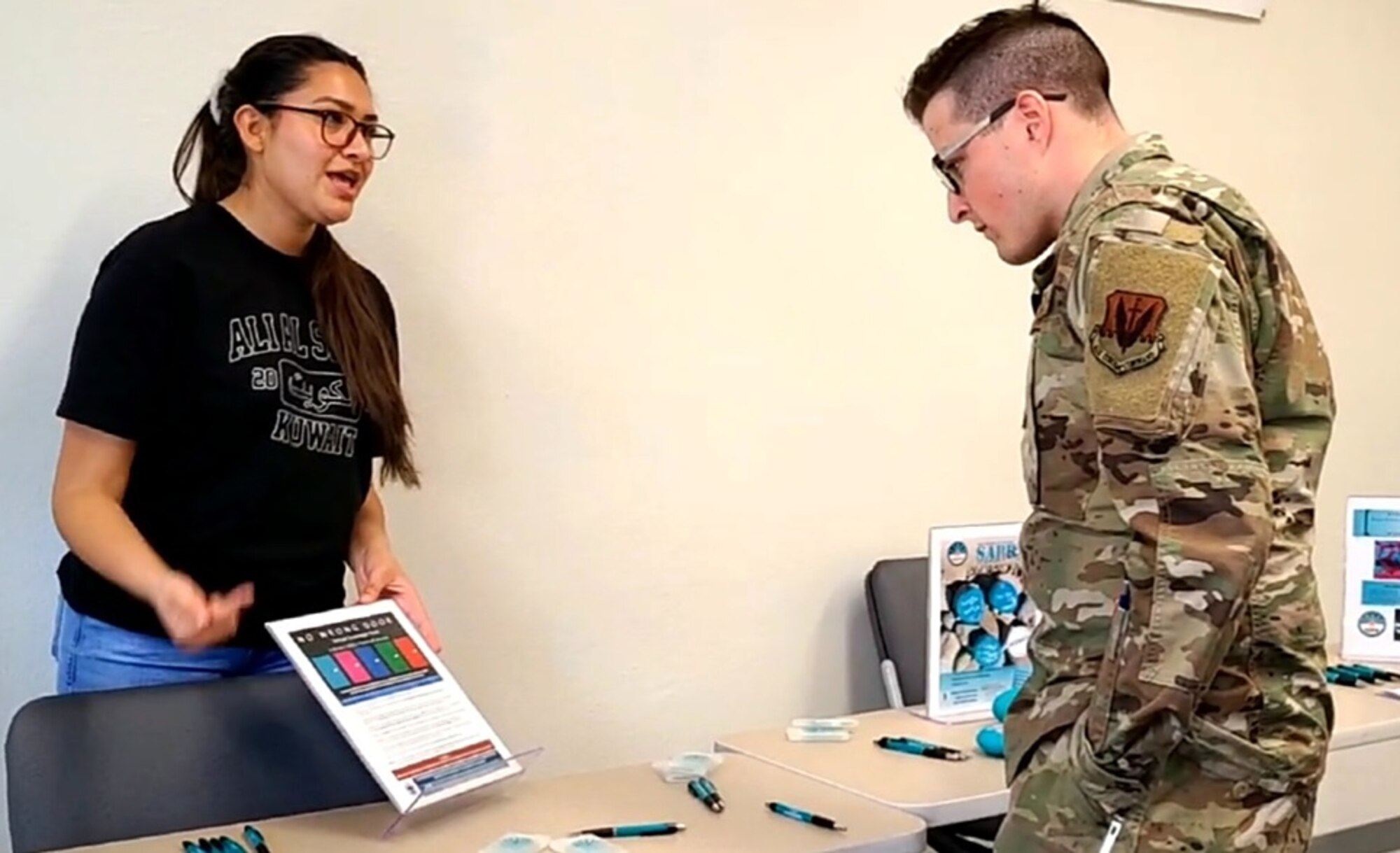 A photo of an Airman being briefed by a volunteer.