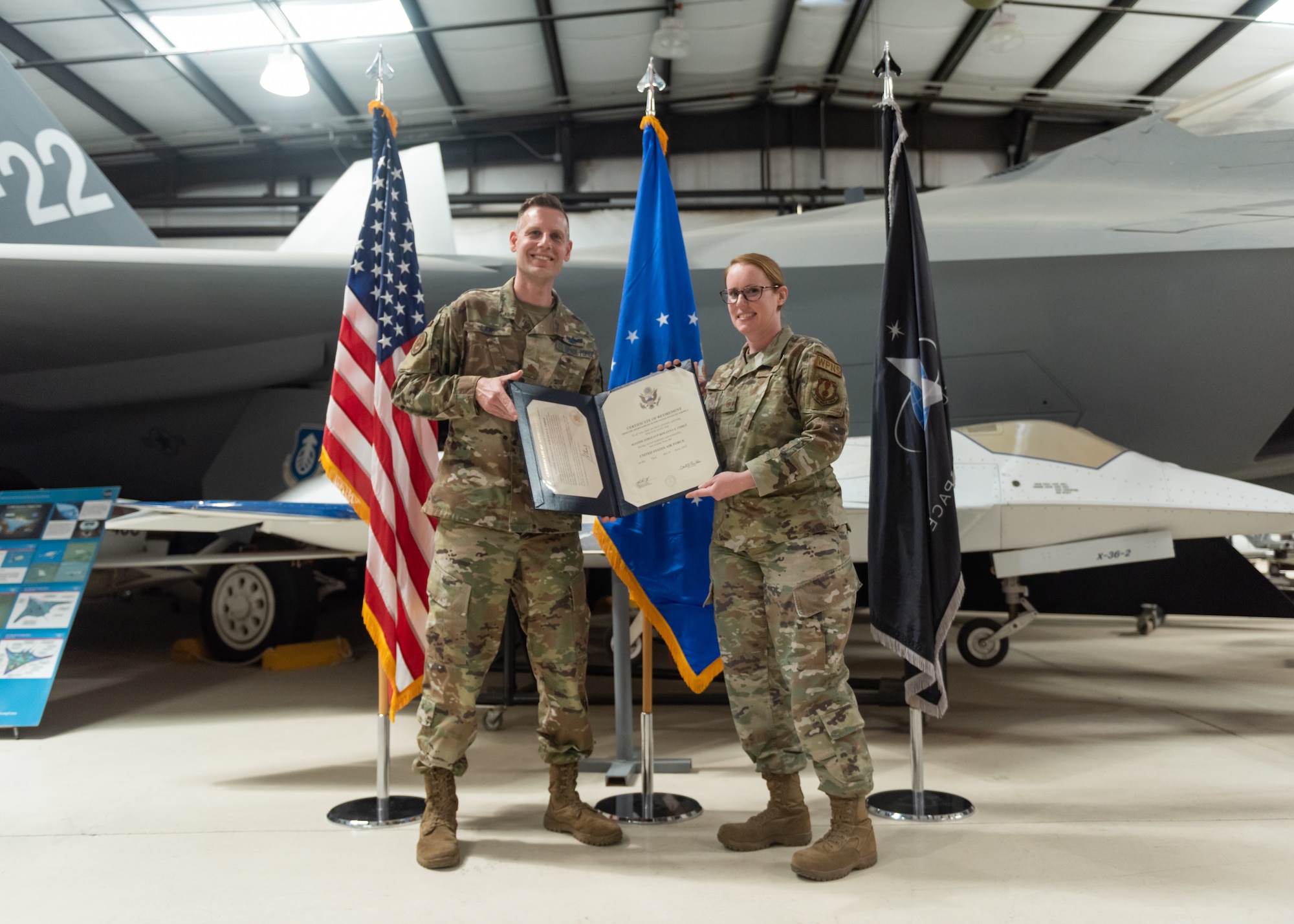 Photo of an Airman receiving her retirement certificate