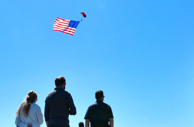 A member of the U.S. Army Special Operations Command parachute team, the Black Daggers, flies the American flag at the Titans of Flight Air Expo, Joint Base Charleston, South Carolina, April 8, 2022.