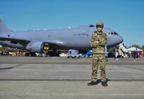 Colton Woody poses in front of a KC-46 Pegasus at the Titans of Flight Air Expo, Joint Base Charleston, South Carolina, April 10, 2022.