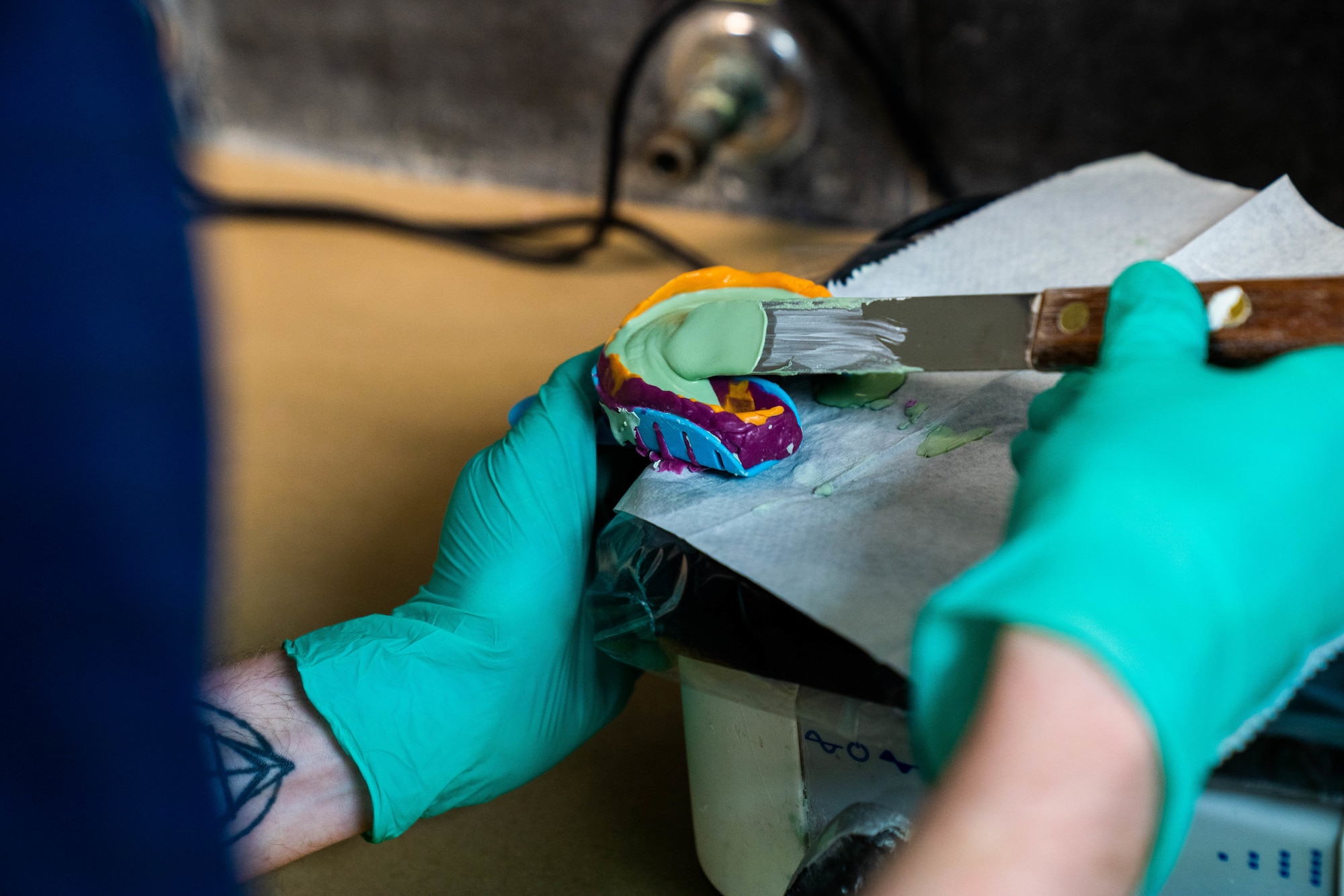 Staff Sgt. Anthony Brown, 15th Operational Medical Readiness Squadron dental lab technician, fills an impression with a material called “stone” to create a mold of the patients teeth in the dental lab at Joint Base Pearl Harbor-Hickam, Hawaii, April 2022. Dental technicians take impressions of the patient’s mouth to design and 3D print crowns, retainers, night guards and other forms of dental gear. (U.S. Air Force photo by Airman 1st Class Makensie Cooper)