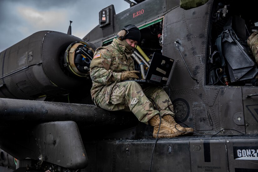 A soldier works on an aircraft.