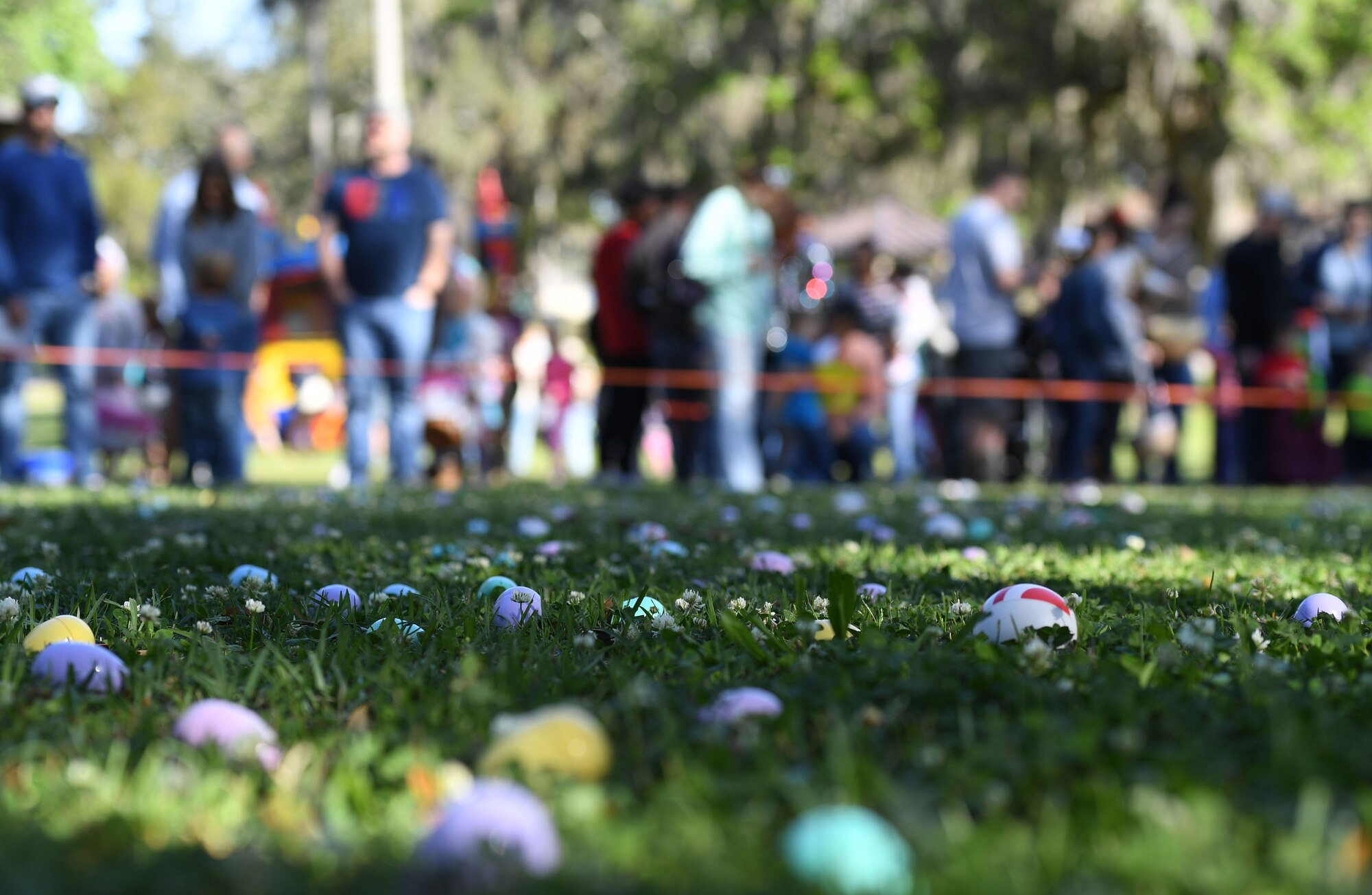Plastic Easter eggs lay in the grass during Keesler's Eggstravaganza at the marina park at Keesler Air Force Base, Mississippi, April 9, 2022. The 81st Force Support Squadron hosted the event for military children. (U.S. Air Force photo by Kemberly Groue)