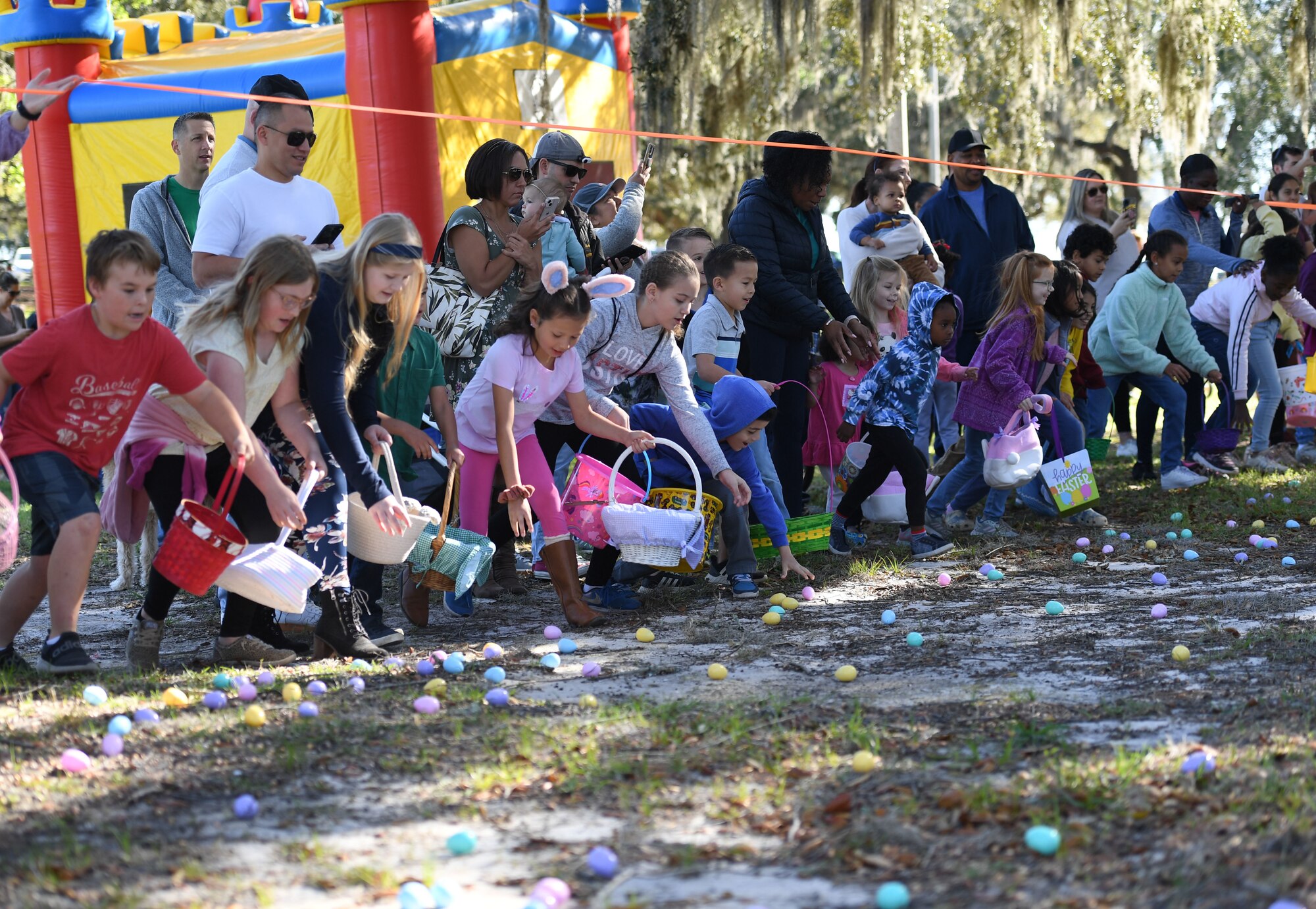 Children of Keesler personnel pick up Easter eggs during Keesler's Eggstravaganza at the marina park at Keesler Air Force Base, Mississippi, April 9, 2022. The 81st Force Support Squadron hosted the event for military children. (U.S. Air Force photo by Kemberly Groue)