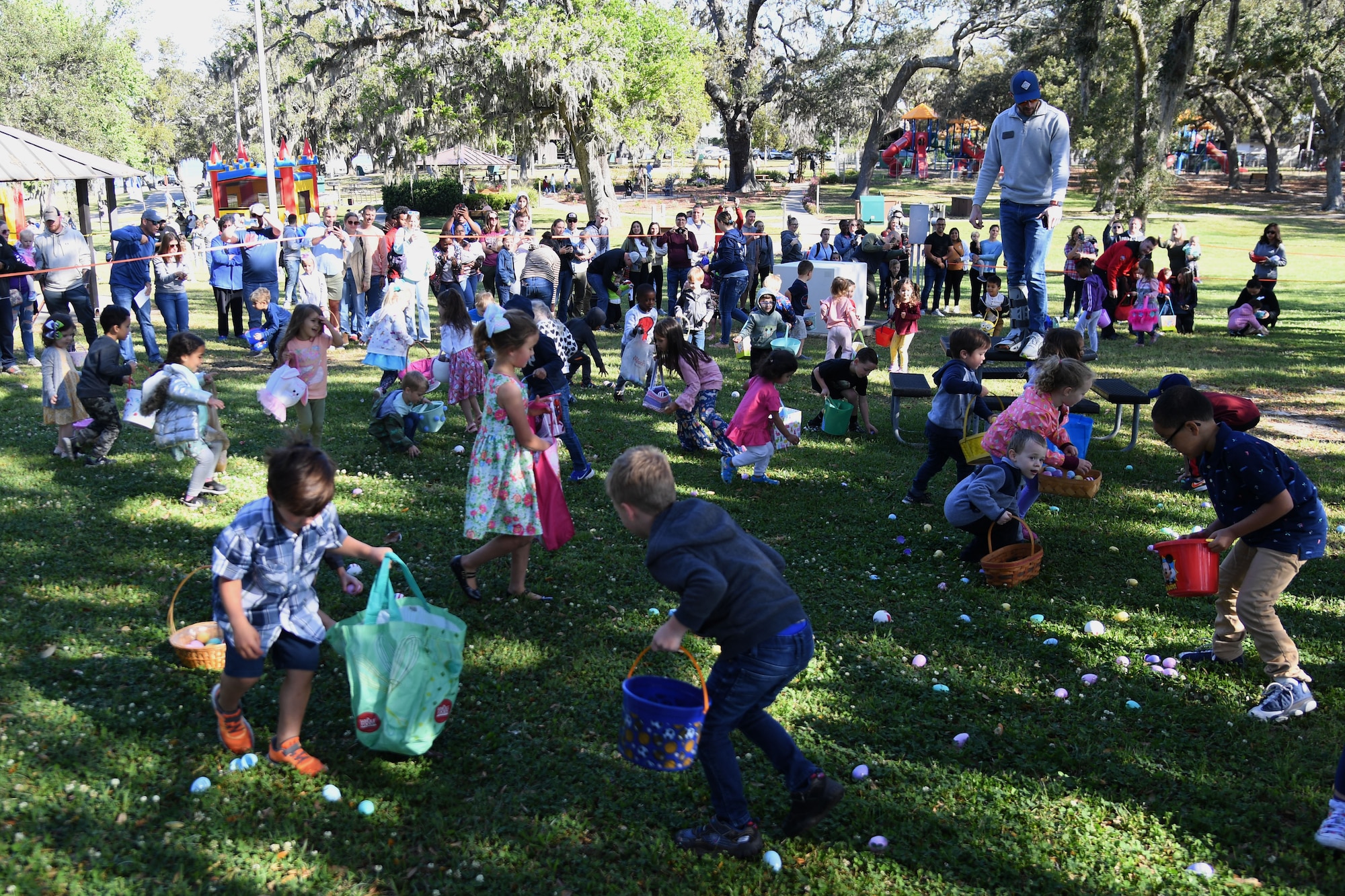 Children of Keesler personnel pick up Easter eggs during Keesler's Eggstravaganza at the marina park at Keesler Air Force Base, Mississippi, April 9, 2022. The 81st Force Support Squadron hosted the event for military children. (U.S. Air Force photo by Kemberly Groue)