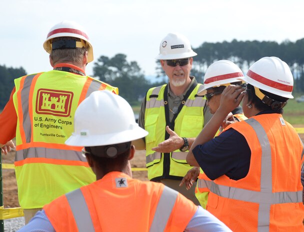 U.S. Army Engineering and Support Center, Huntsville employees receive a site briefing by a SunPower Corporation contractor before visiting a solar array construction site on Redstone Arsenal in 2017. Projects like the Arsenal’s The 10 MW solar array with a 1-MW storage system undergo reviews by the Center’s Energy Resilience and Conservation Investment Program validation team before they are submitted to compete for Department of Defense funding.