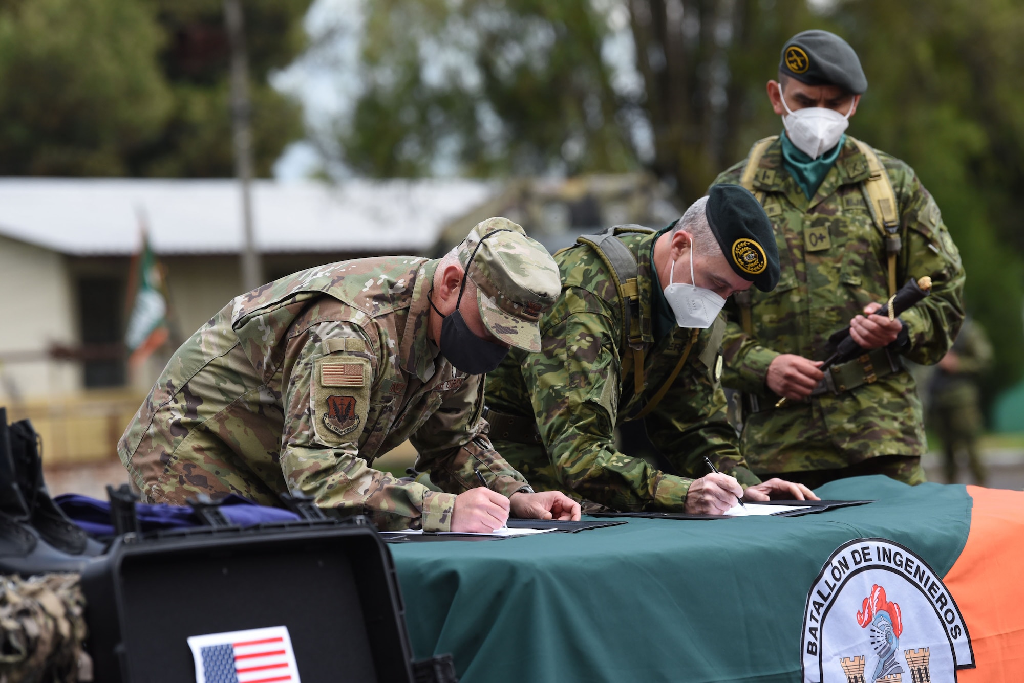 Col. Jaime Gómez (left), U.S. Senior Defense Official, and Brig. Gen. Edwin Adatty (right), Commander, Ecuadorian Army Corps of Engineers, sign equipment transfer documents at a ceremony held on Feb. 25, 2022, in Sangolquí, Ecuador. The equipment, from U.S. Southern Command, will be used to help clear the last remaining part of the country's southern border so it can be returned to the local population for farming and other activities. (U.S. Air National Guard photo by Lt. Col. Allison Stephens)