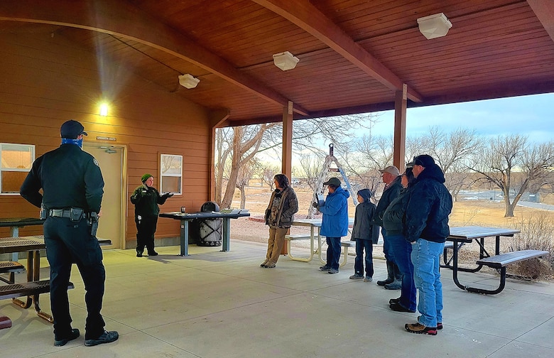 John Martin Park Ranger Dr. Sara Harrod (second from left) speaks with volunteers about eagle survey protocols before the start of the eagle watch at John Martin Reservoir, Colo., Jan. 8, 2022.