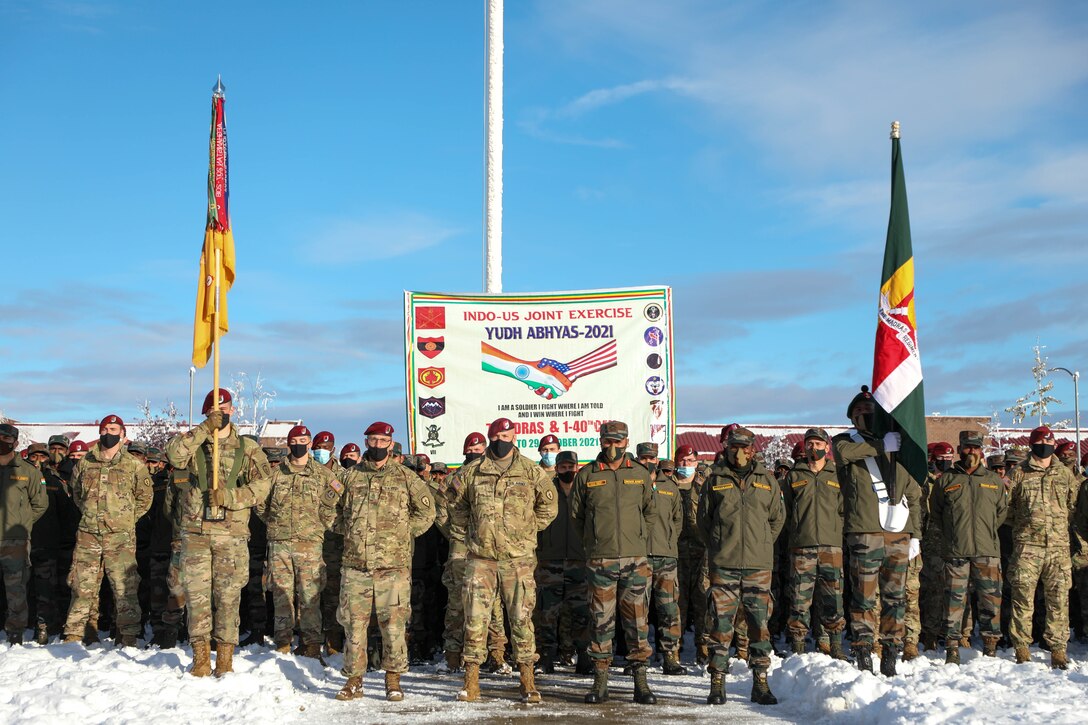 U.S.-Indian soldiers stand together in snow.