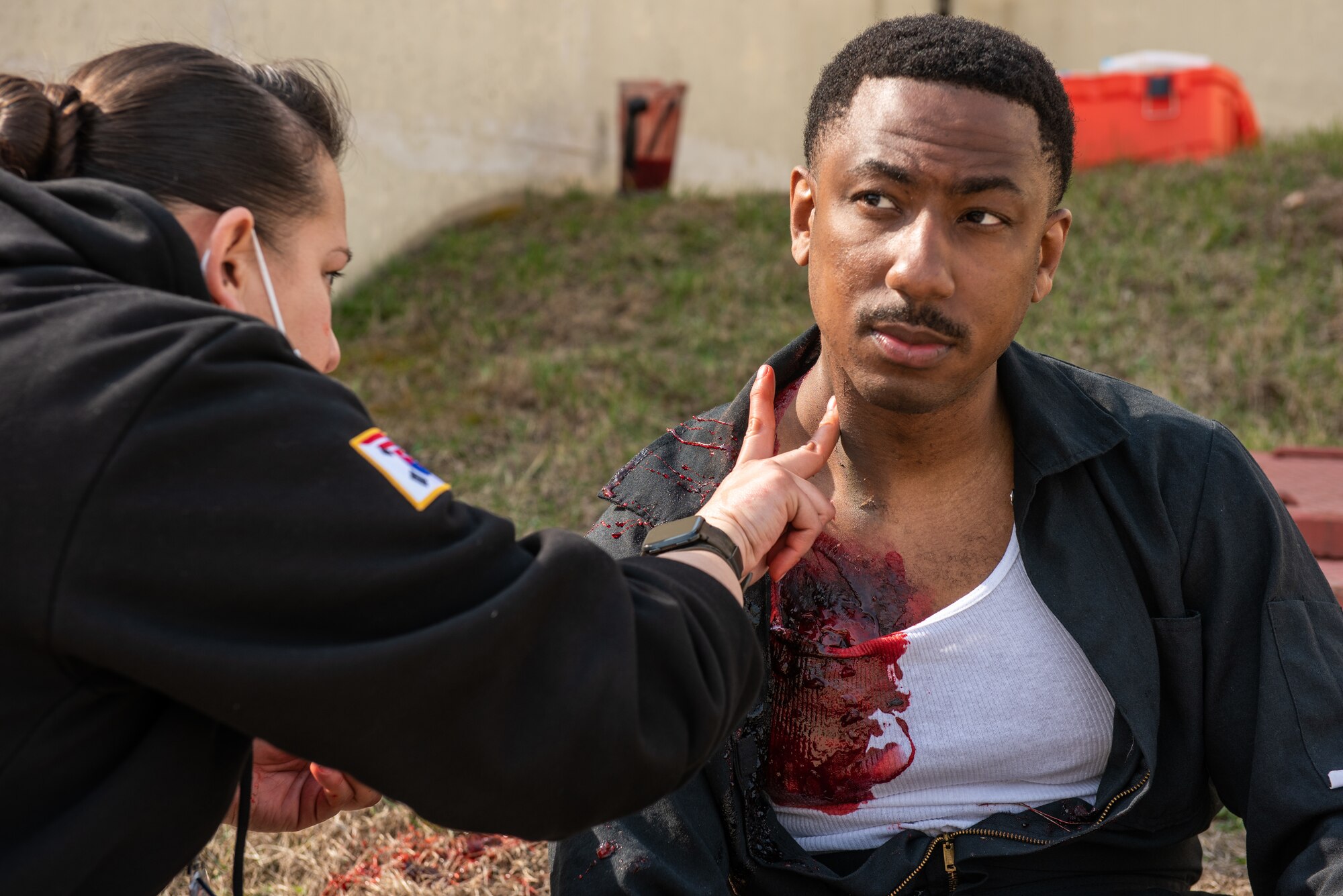 Staff Sgt. Desiree Castro, 51st Medical Group emergency medical technician, applies moulage makeup to Tech. Sgt. Gerard Thomas, 51st Civil Engineer Squadron fire department station chief, as part of a national registry emergency medical technician training scenario at Osan Air Base, Republic of Korea, April 5, 2022.