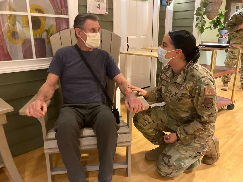 A guardsman talks to a man.