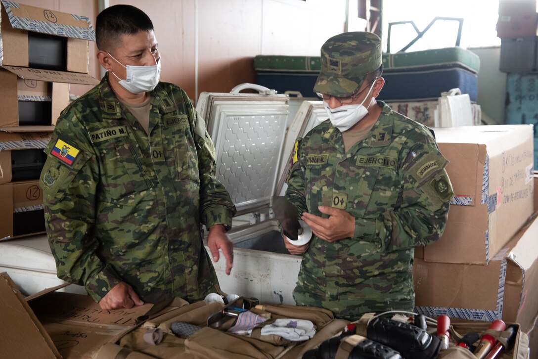 Ecuadorian Army personnel inspect and log a demining kit during an equipment transfer from U.S. Southern Command on Feb. 23, 2022, in Sangolquí, Ecuador. The new kit has improved tools and is lighter to carry as they travel through the jungle. (U.S. Air National Guard photo by Lt. Col. Allison Stephens)