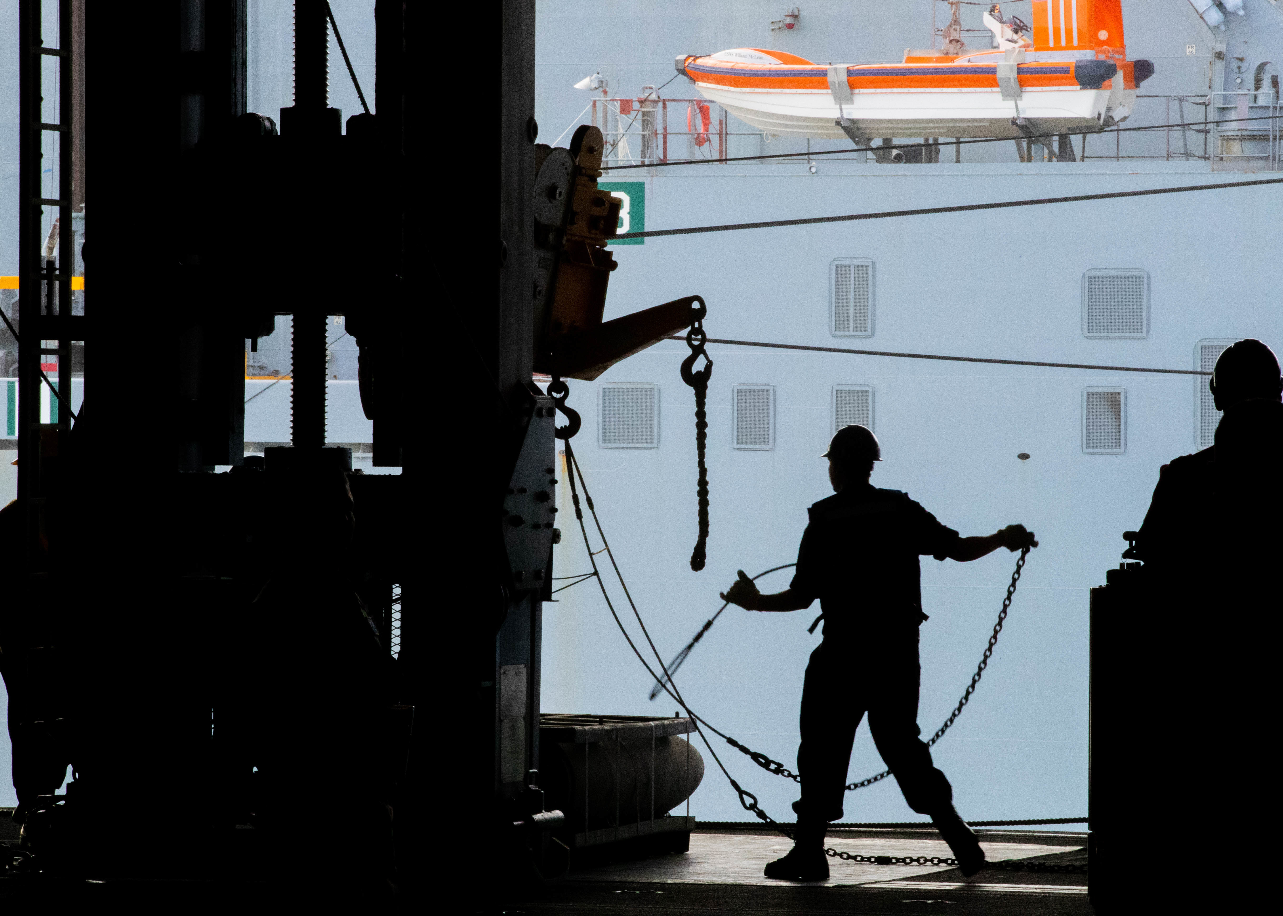 A Sailor unloads a standard underway replenishment fixture during an ammunition on-load with the Military Sealift Command Lewis and Clark-class dry cargo ship USNS William McLean (T-AKE 12)