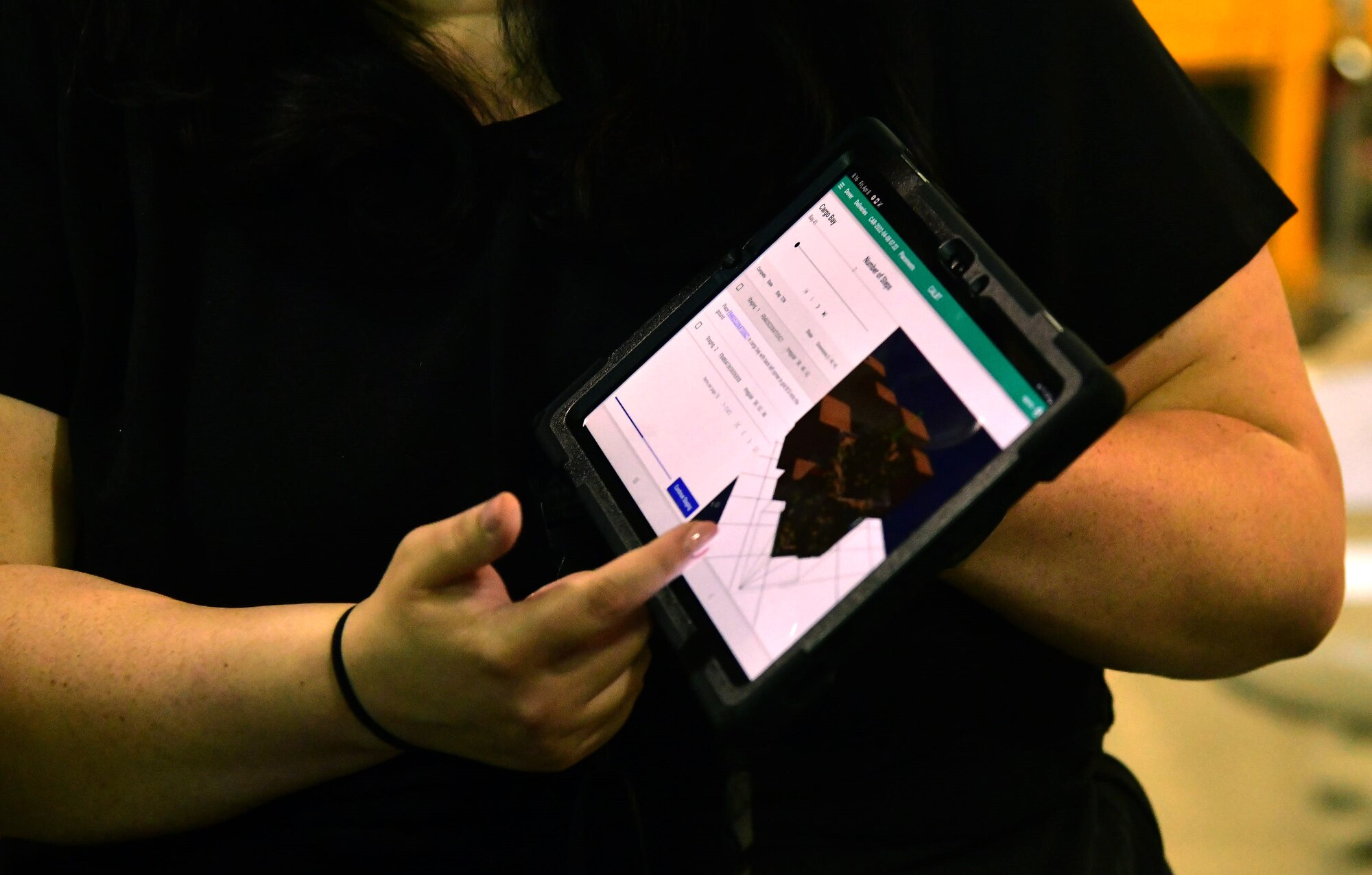 Angela Garza, Cougaar Software senior operations research engineer, demonstrates software capabilities of the Configured Air Load Building Tool at Dover Air Force Base, Delaware, April 8, 2022. The software company developed the CALBT, as part of the "Aerial Port of the Future" initiative, to maximize pallet space utilization within Air Mobility Command. (U.S. Air Force photo by Master Sgt. Chuck Broadway)