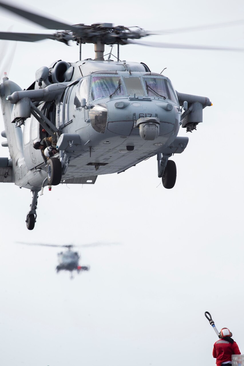 An MH-60S Nighthawk prepares to transport ammunition to the aircraft carrier USS Gerald R. Ford (CVN78) during an ammunition on-load with USNS William McLean (T-AKE 12), April 9, 2022.