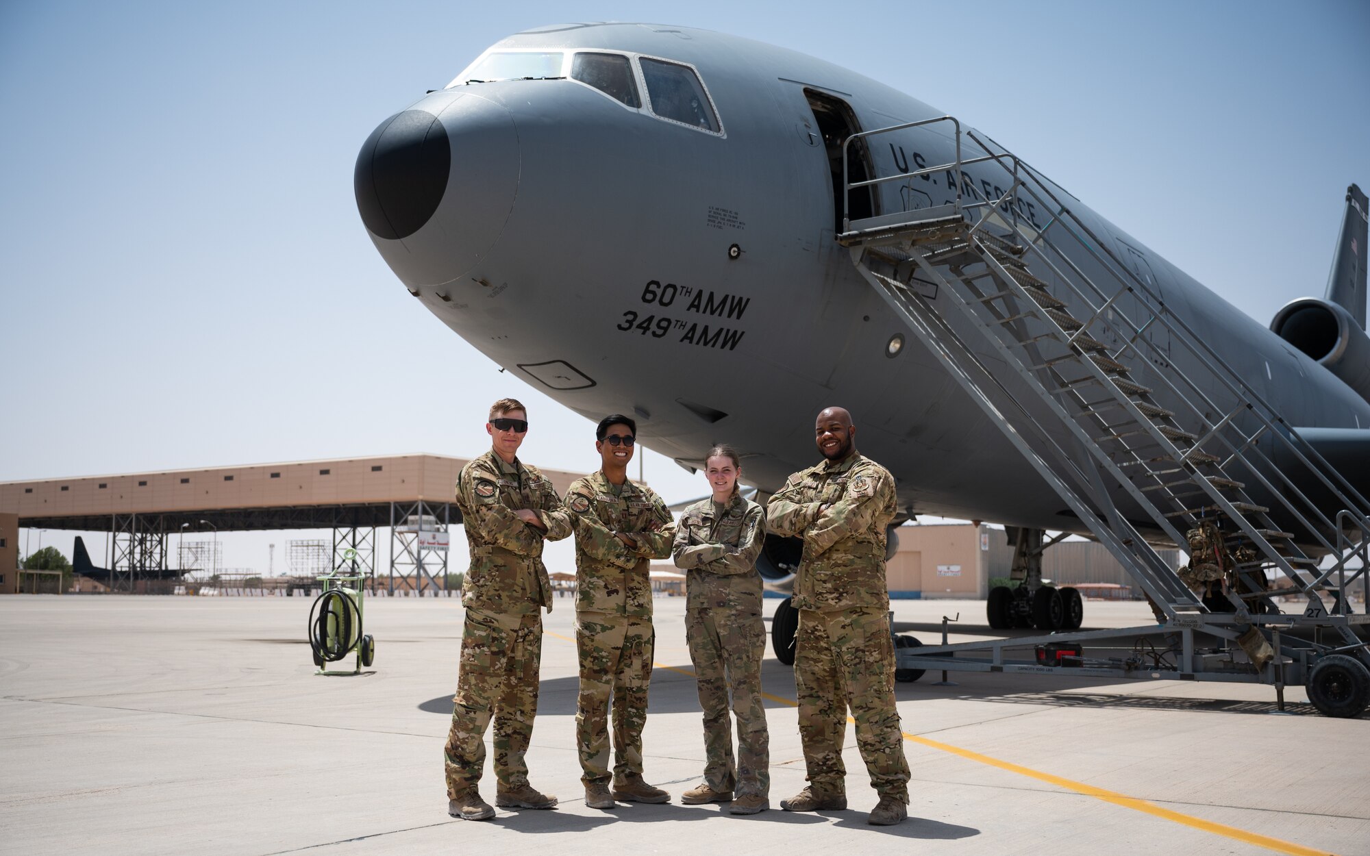 U.S. Air Force Capt. Gavin Owens 908th Expeditionary Air Refueling Squadron aircraft commander, Capt. Kevin Cabusora, 908th EARS aircraft commander, Airman 1st Class Lauren Hotaling, 908th EARS in-flight refueling specialist, and Tech. Sgt. Justin Lassiter, 908th EARS instructor flight engineer, pose for a photo in front of a KC-10 Extender at Prince Sultan Air Base, Kingdom of Saudi Arabia, April 7, 2022. The crew deployed from the 305th Air Mobility Wing, McGuire Air Force Base, New Jersey, and are the last crew to fly a KC-10 sortie deployed. McGuire AFB will cease their KC-10 deployments as the base is transitioning to fly the KC-46 Pegasus. (U.S. Air Force photo by Senior Airman Jacob B. Wrightsman)