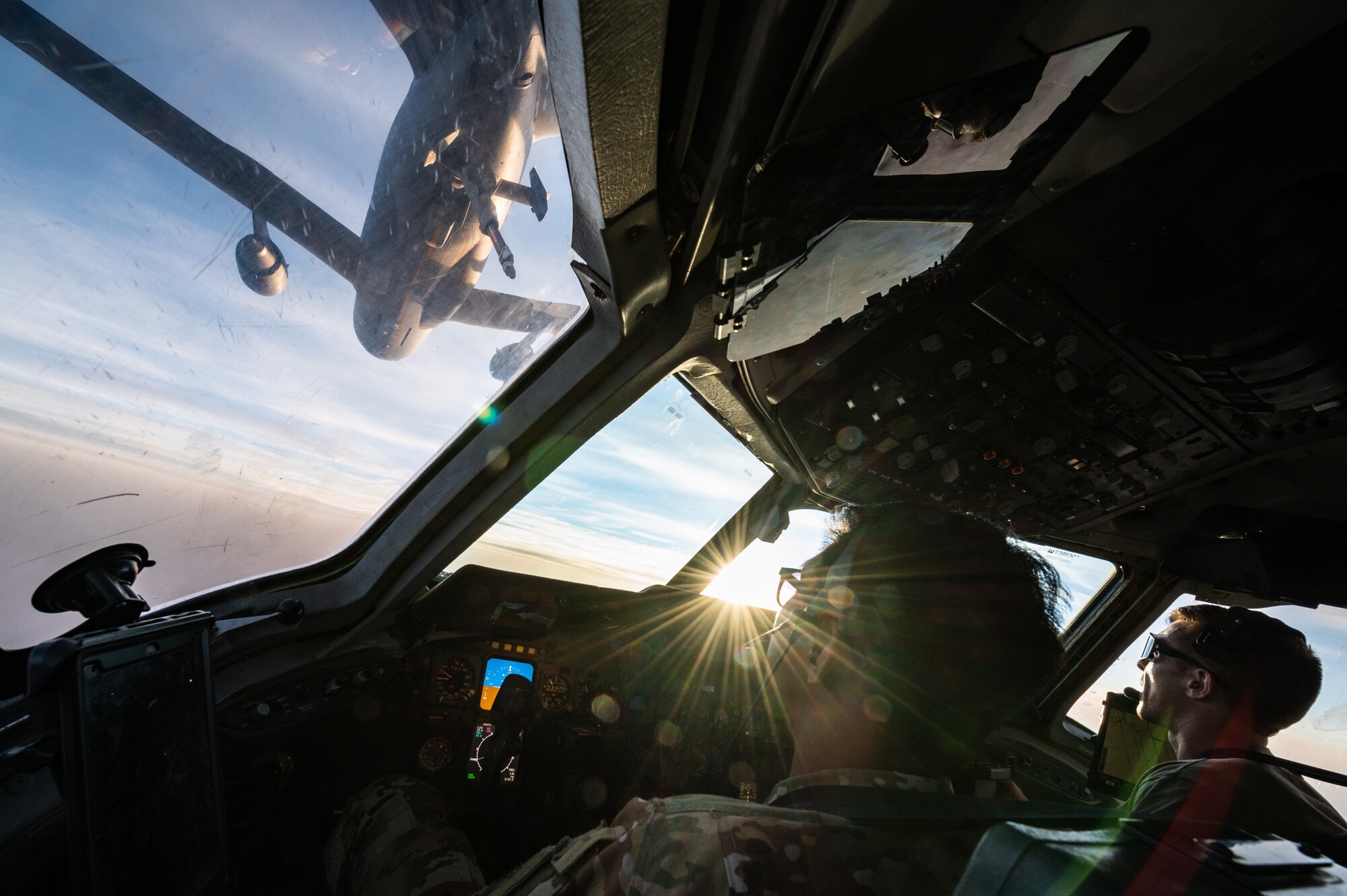 U.S. Air Force Capt. Kevin Cabusora, 908th Expeditionary Air Refueling Squadron KC-10 Extender aircraft commander and Capt. Gavin Owens 908th EARS instructor pilot, connect to another KC-10 for aerial refueling over the U.S. Central Command area of responsibility, April 7, 2022. Cabusora, Owens and the rest of the aircrew, deployed from the 305th Air Mobility Wing, McGuire Air Force Base, New Jersey, are the last crew to fly a KC-10 sortie deployed. McGuire AFB will cease their KC-10 deployments as the base is transitioning to fly the KC-46 Pegasus. (U.S. Air Force photo by Senior Airman Jacob B. Wrightsman)