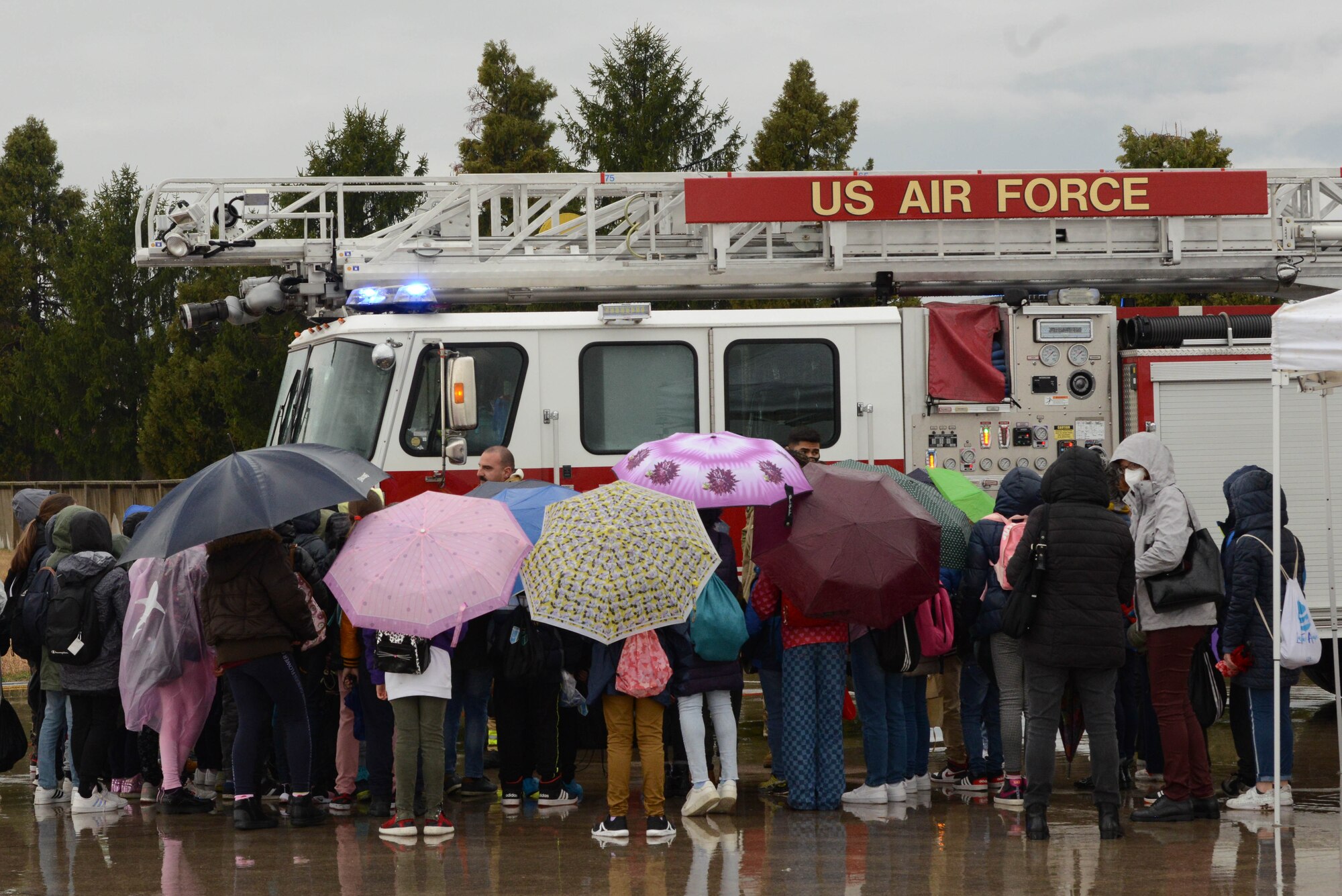 Children view a fire truck during an open house at Aviano Air Base, Italy, April 1, 2022. The U.S. Air Force and Italian air force organized the demonstration for military children as well as local community school children in honor of the Month of the Military Child. Students viewed a variety of static displays and the Frecce Tricolori Italian air force aerobatics team performed aerial maneuvers. (U.S. Air Force photo by Airman 1st Class Thomas Calopedis)